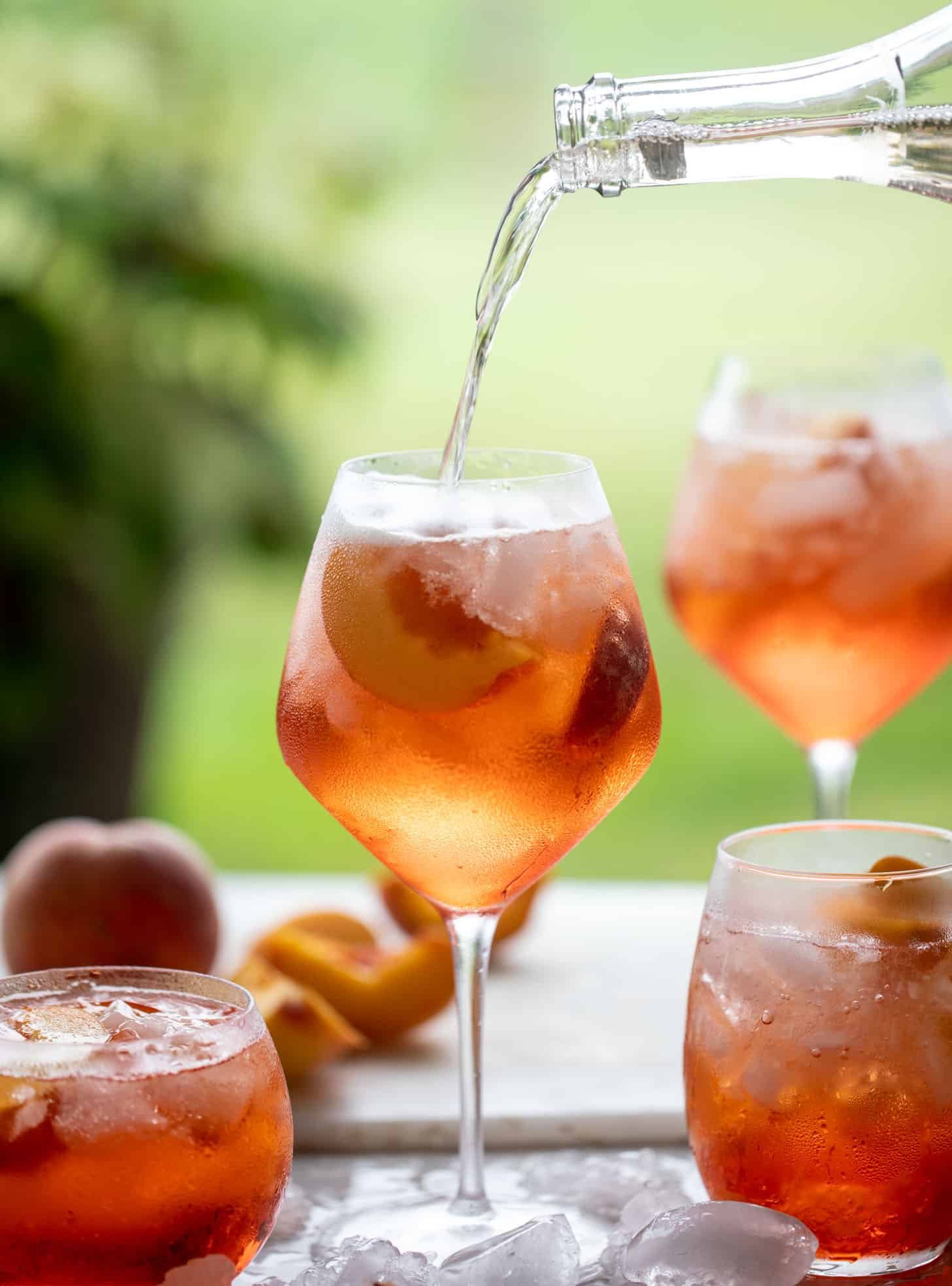 pouring sparkling rosé in aperol spritz 